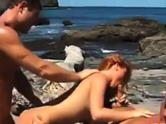 hot-redhead-in-a-threesome-at-a-beach